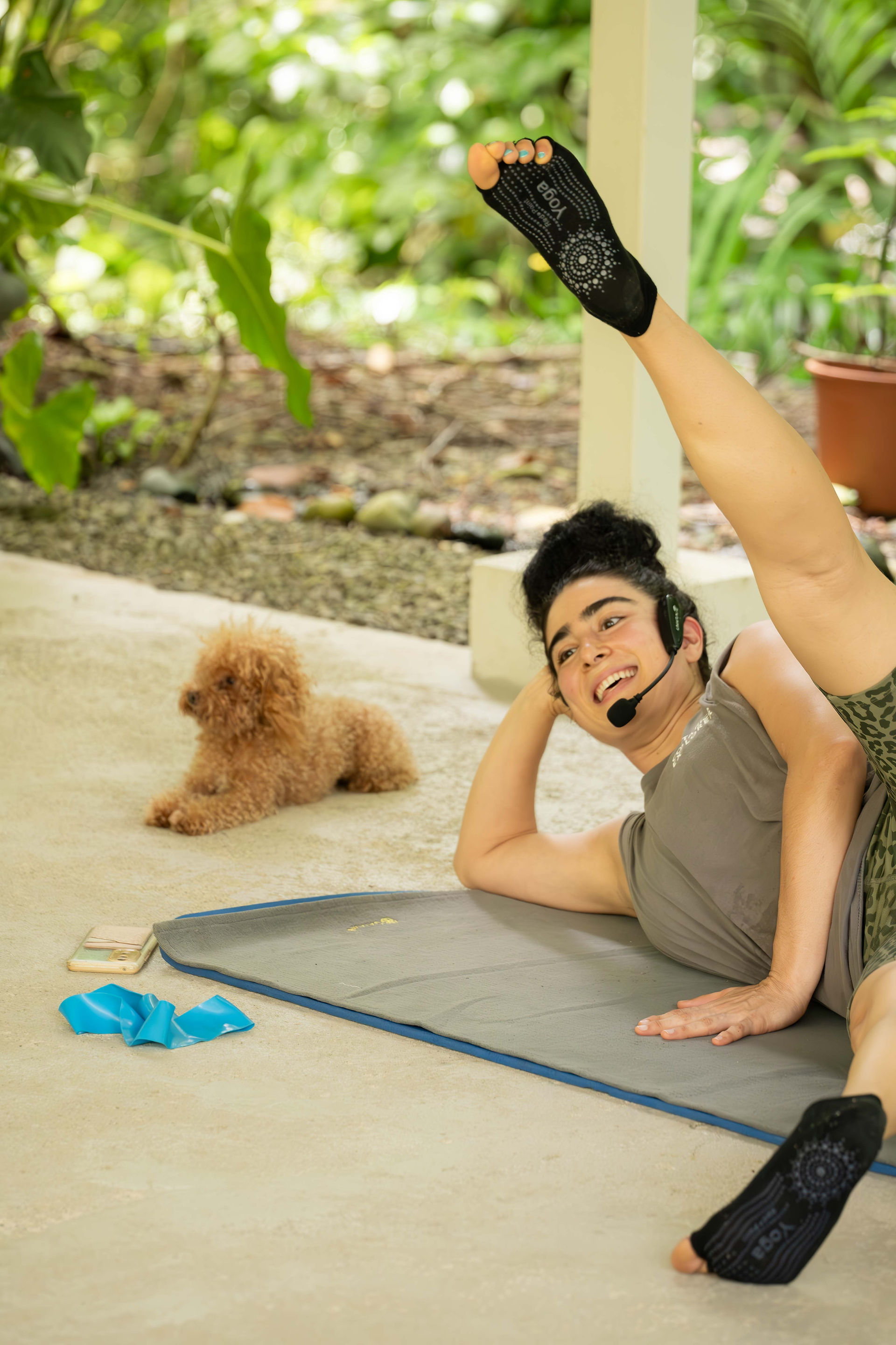 Smiling pilates teacher with dog