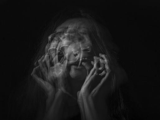 A woman screaming in pain from her suffering