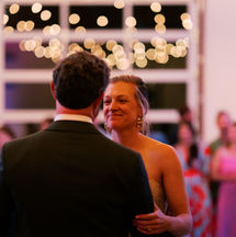Bride smiling at groom during first dance at wedding reception, Moon Magnet wedding DJ and MC