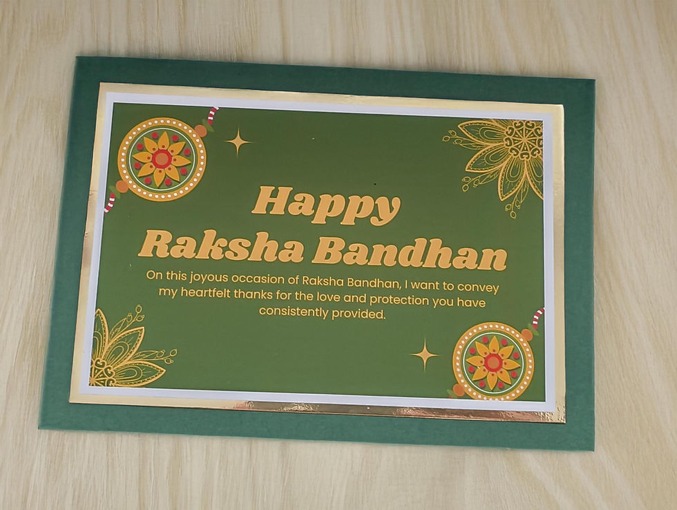 Handmade Raksha Bandhan greeting card in green and gold with rakhi design, displayed on wood surface