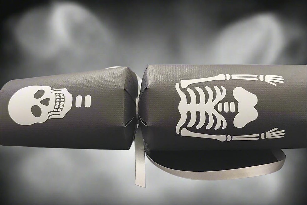 Close-up of black Halloween skeleton cracker showing skull and ribcage details with silver ribbon.