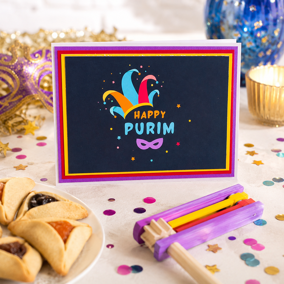 Happy Purim greeting card on a bright festive table with hamantaschen, grogger, confetti and mask decor.
