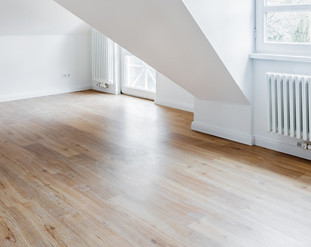 Hardwood floor and white room