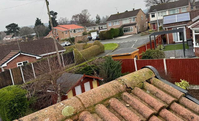 Close-up of loose ridge tiles, requiring repair to prevent structural issues.