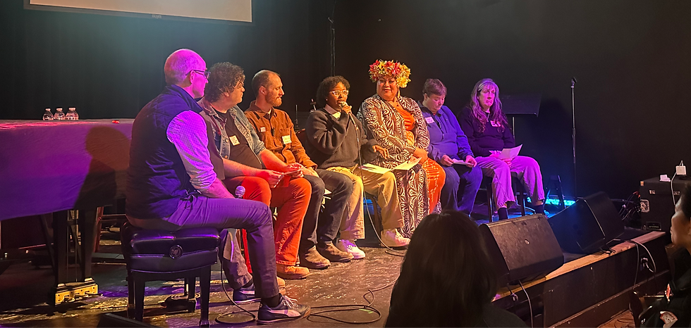 Six people sitting on a stage having a discussion.
