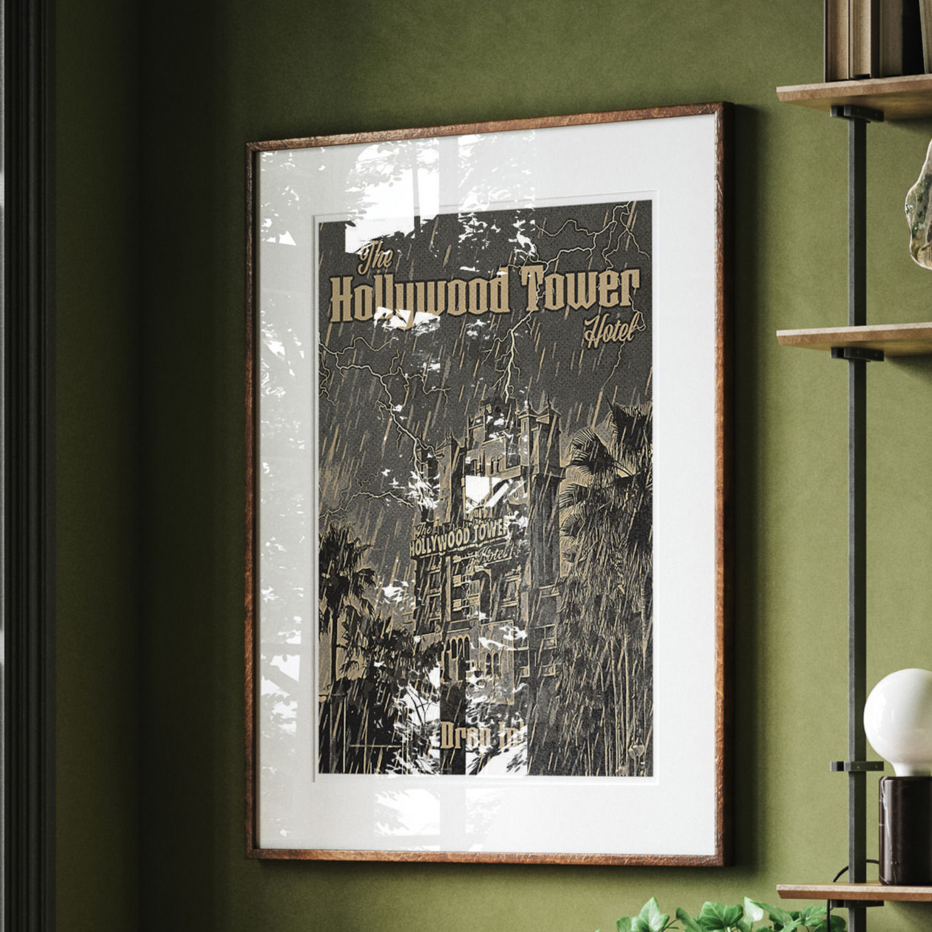 The Hollywood Tower Hotel print hanging on a dark green wall