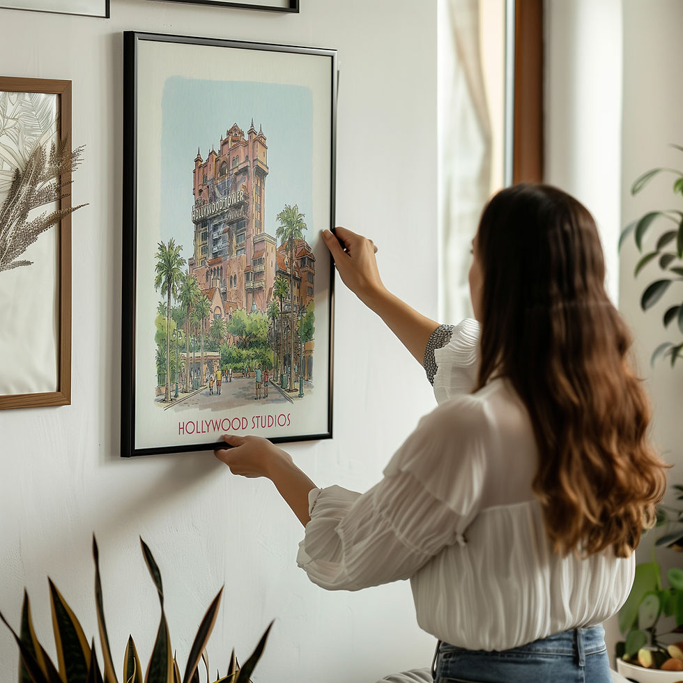 Thumbnail: Woman hanging a framed Hollywood Tower Hotel print on a wall