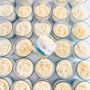 rows of votive candles topped with a wax peony flowers