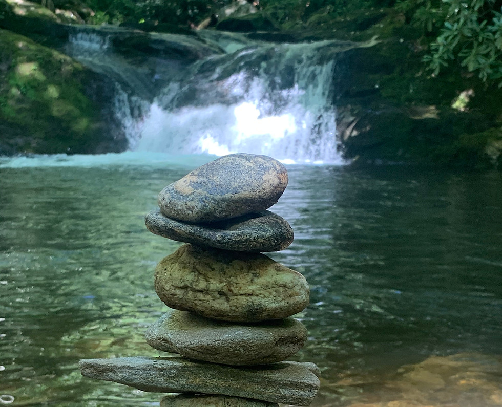 Highland NC Grounding Stones stacked in front of waterfall