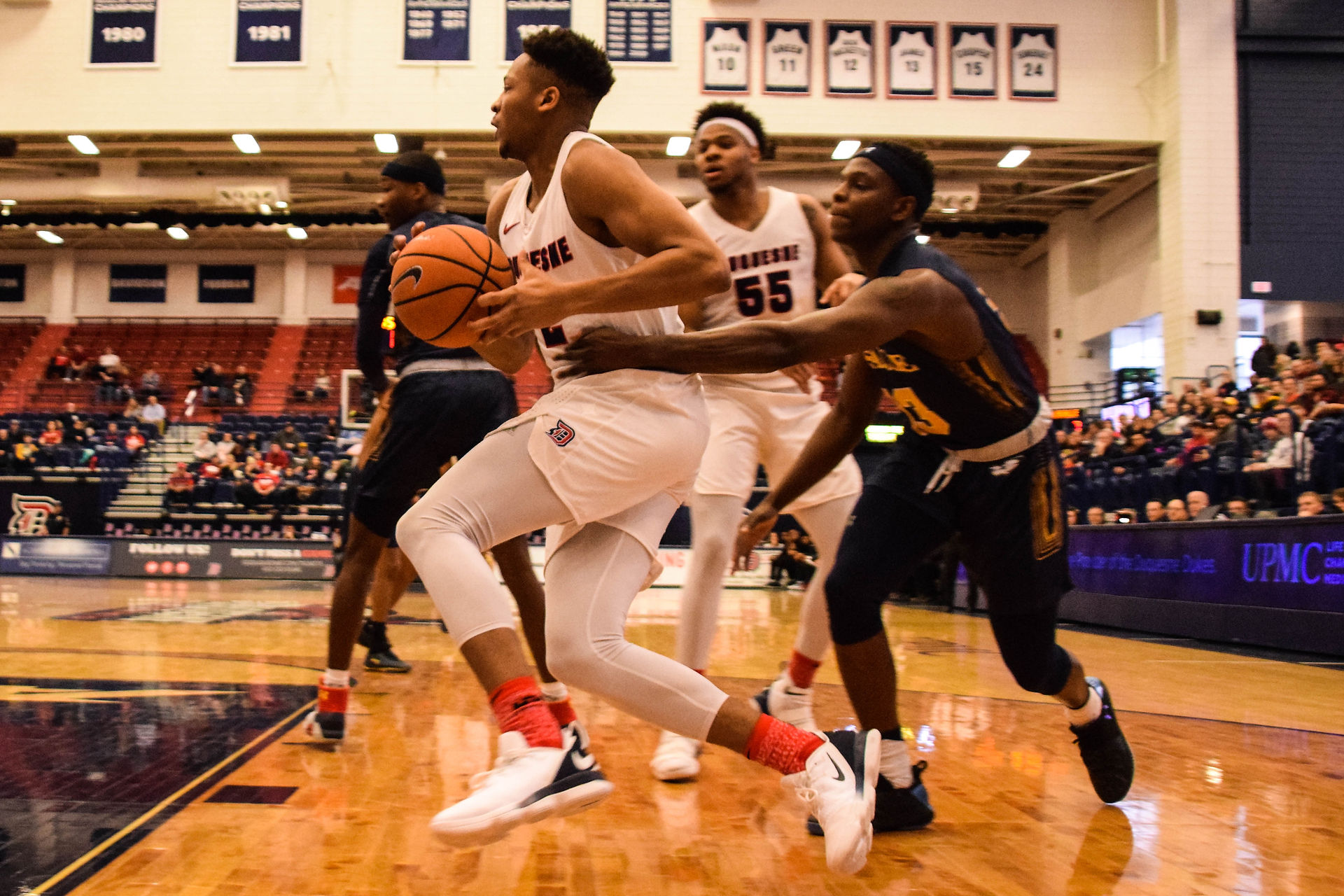 Eric James (2) drives along the baseline against La Salle.