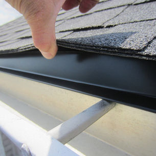 Professional roofer installing architectural shingles on Pittsburgh home with proper flashing and ventilation systems