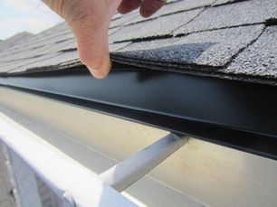 Professional roofer installing architectural shingles on Pittsburgh home with proper flashing and ventilation systems