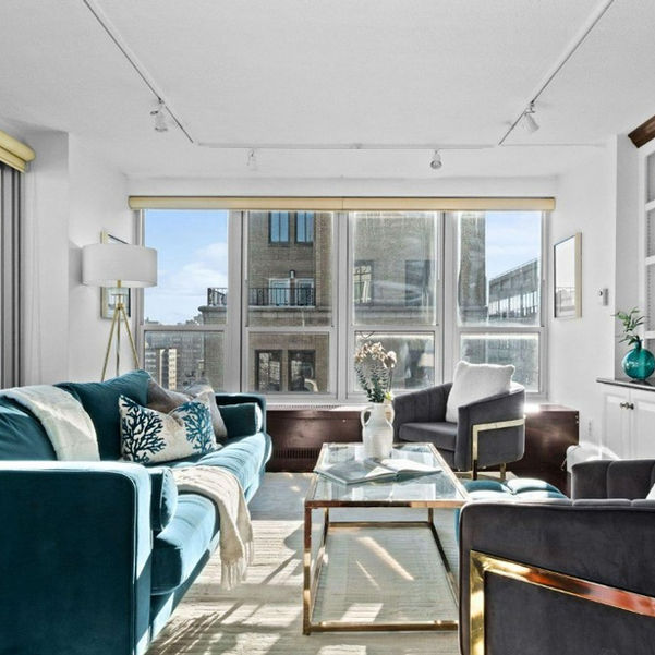 Luxurious high-rise living room in gold and green jewel tones