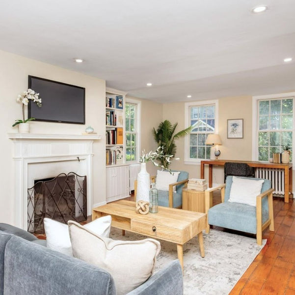 Living room with built-in bookshelves and elegant fireplace