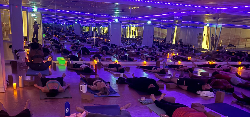 Yin Yoga students lying down in relaxing yoga pose.