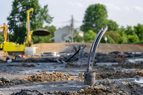 Casing pipe with polyethylene ground loop pipes in the process of being installed in a new