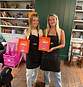 Cocktail class, 2 girls holding paintings