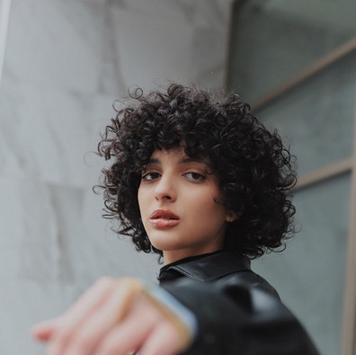 Model holding her hand towards camera