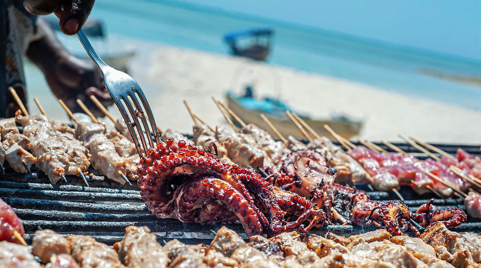 A woman grilling seafood on a Beach Barbecue in New Smyrna Beach, FL.