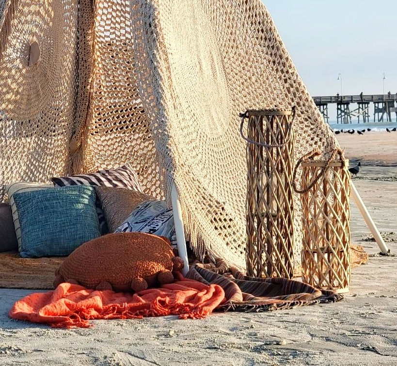 A Beach Teepees setup filled with plush pillows and soft throws.
