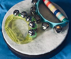 a drum with hand bells on top