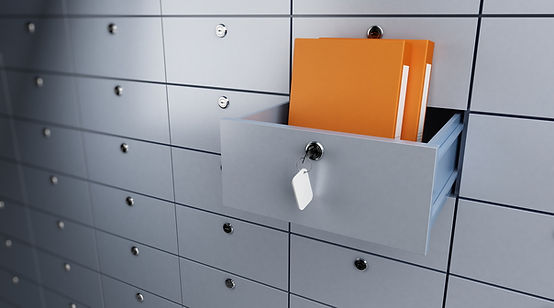 Photo of a safe deposit box facility where one of the boxes is open and inside are two orange document holding folders