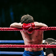 Boxer Leaning on Ropes