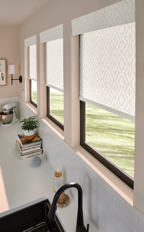 Modern kitchen with patterned shades, featuring a sink area and natural light – Lumen Shade Solutions window treatments.