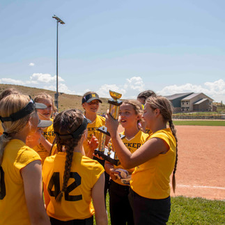 Meeker's 11-13 year old team celebrates with the trophy.
