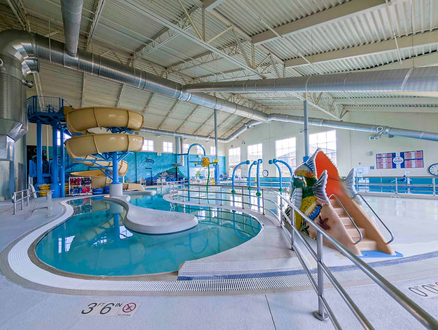 Indoor aquatic center with water slides and pools.