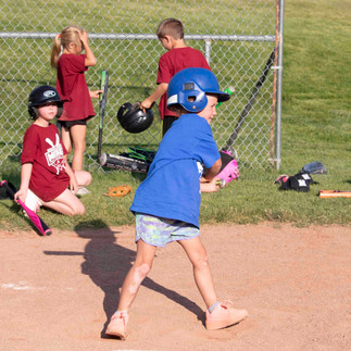 Youth baseball players practicing batting
