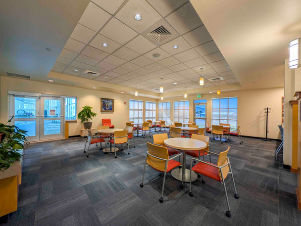 Meeker Rec Center lounge with round tables and colorful chairs