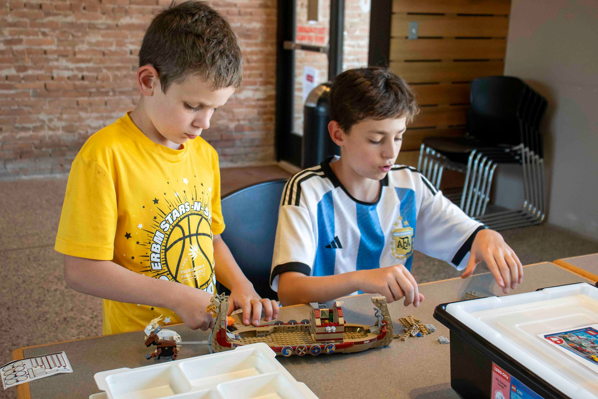 Two boys building Lego pirate ship