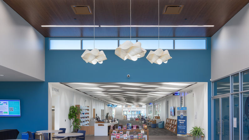 Front entrance to the newly renovated St. Petersburg Library System, President Barack Obama Main Library. Featuring high ceilings with dark wood, highlighted with modern, elegant light fixutres.