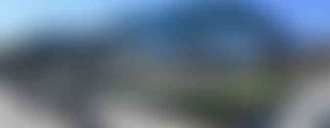 Outdoor bocce and shuffleboard courts with sleek blue canopy shades and seating, creating an inviting recreational space at Afton Ridge Library & Active Living Center.