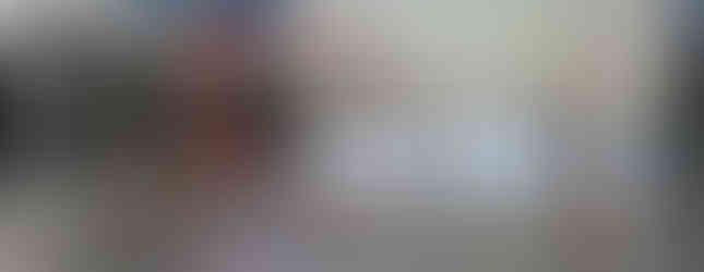 Bright, multi-purpose space with floor-to-ceiling windows, a badminton setup, and a retractable screen, ideal for recreation and events at Afton Ridge.