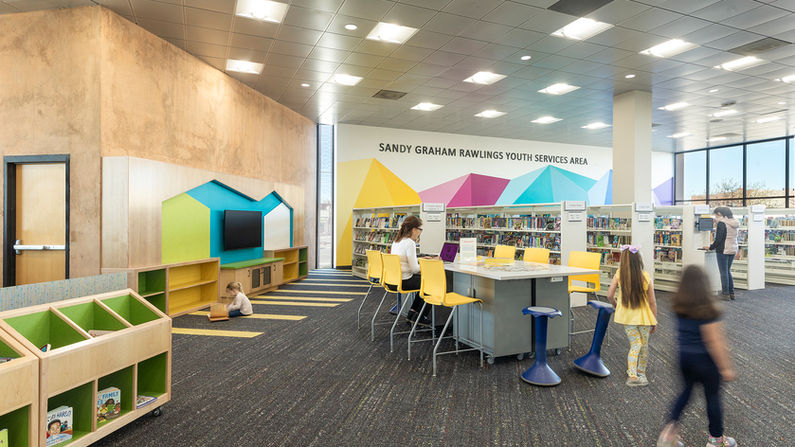 Pueblo City-County Library, Rawlings Branch, tween zone. This area allows tweens to study, mingle, and learn in a comfortable and visually calm environment. Adding pops of color among the light wood helps the area stand out in its own defined way.