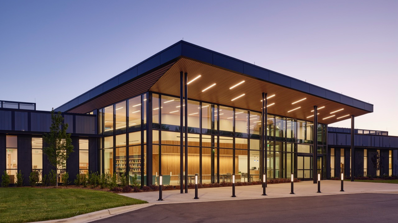 Exterior evening view of the striking front facade of the new Cabarrus County Afton Ridge Library and Active Living Center. This project received the 2026 AIA West Virginia Honor Award.
