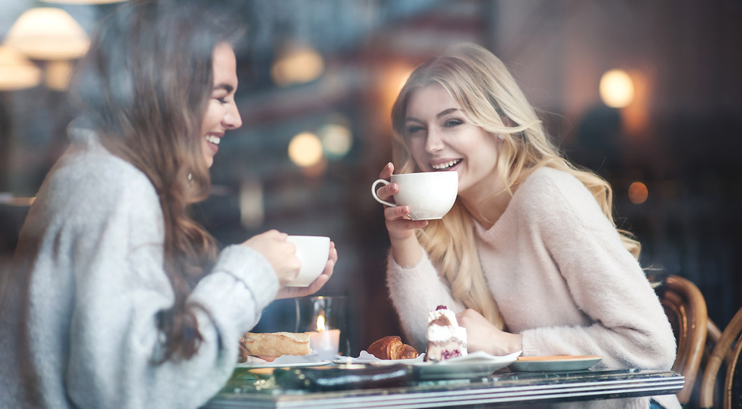 Two girl friends drinking coffee in the cafe.jpg