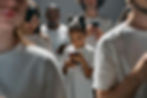 Group of people focused on their smartphones, symbolizing Gen Z’s digital-first habits.