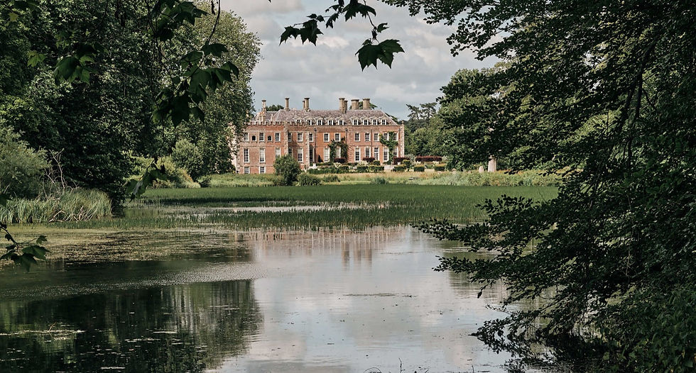St Giles House, Wimborne St Giles: the Dorset stately home seen across its lake through the trees