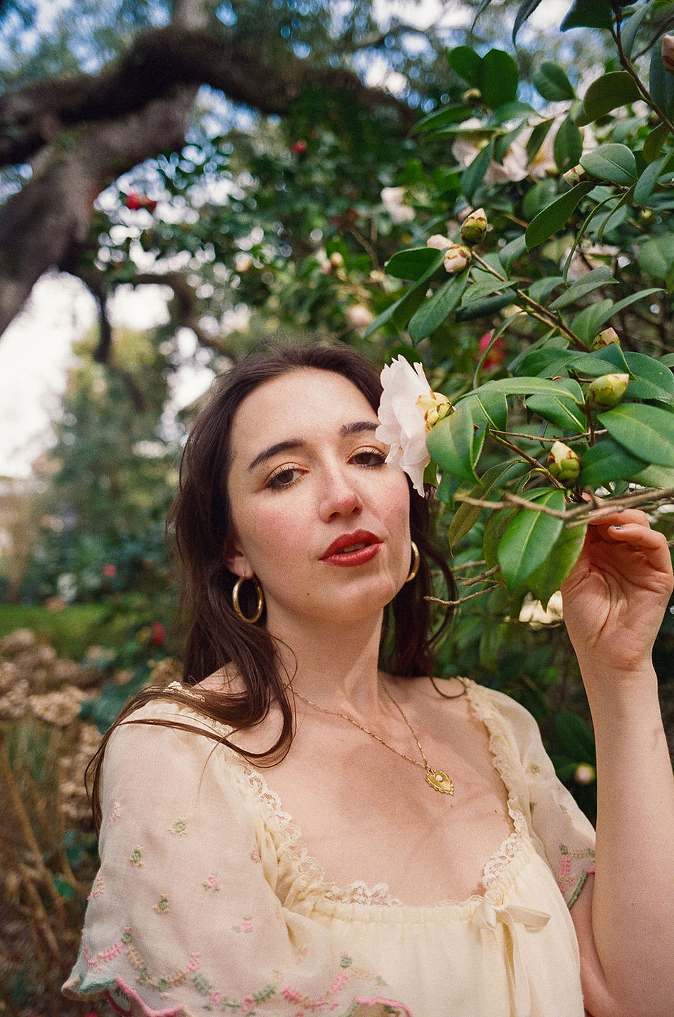 Film portrait of bride under Spanish moss-lined live oaks in Forsyth Park