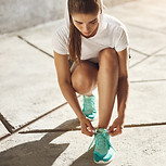 Teenager tying up trainers, ready to run