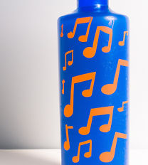 orange water bottle with blue music notes printed all over it.jpg