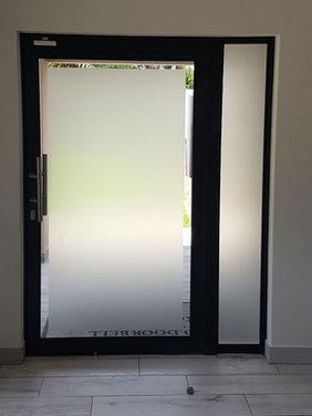 Residential ceramic window tint for privacy on a glass door