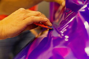 person-applying-purple-vinyl-wrap-to-surface-2026-03-18-05-44-14-utc (1).jpg