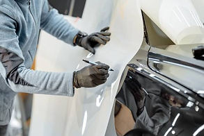 man-applying-vinyl-film-to-car-in-workshop-2026-01-09-09-06-29-utc (1).jpg