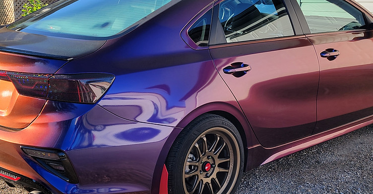 Custom color-shift vinyl wrap on sports car with gloss and metallic finish