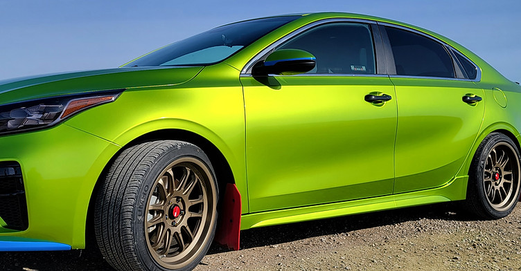 Bright green vinyl-wrapped sports car parked outdoors after full color change wrap