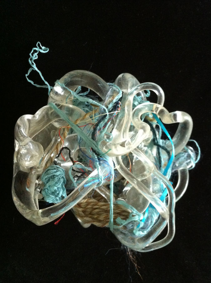 Glassed Dance sculpture with clear glass ribbons and fiber ribbons woven through. Mixed Media- fibers and hand blown glass, 8 inches by 8 inches, 2009.